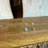 Close-up of earrings on a wooden surface with a blurred background