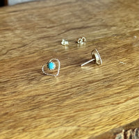 Silver earrings on a wooden surface