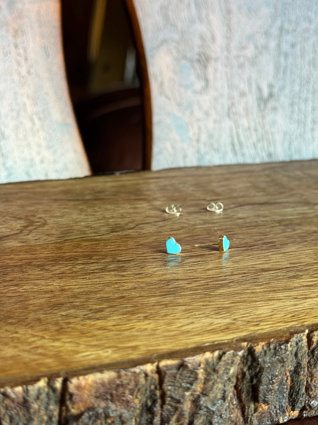 Close-up of earrings on a wooden surface with a blurred background