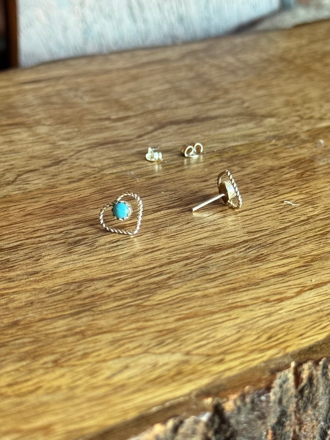 Silver earrings on a wooden surface