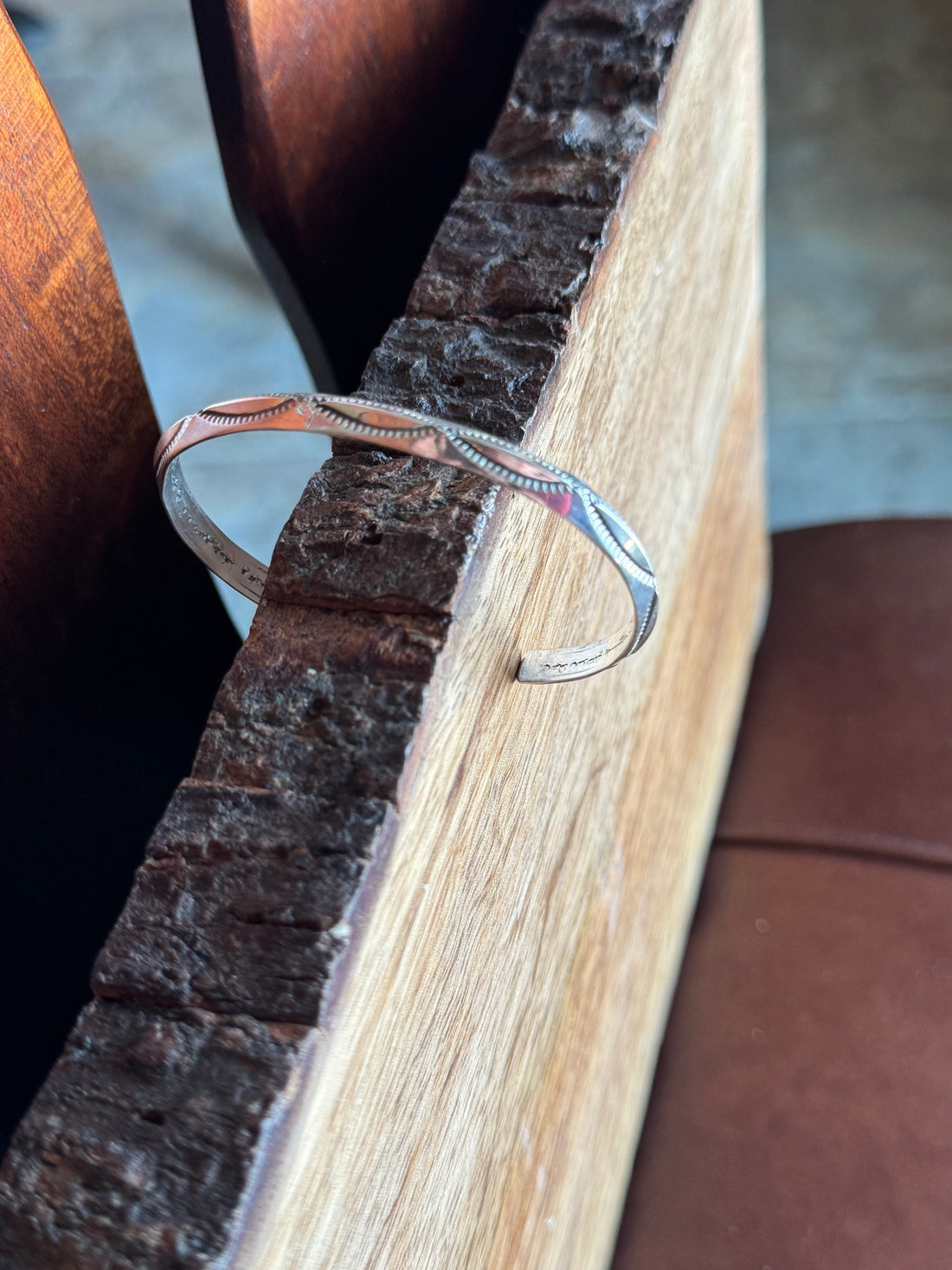 Silver bracelet on a wooden surface