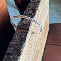 Silver bracelet on a wooden surface