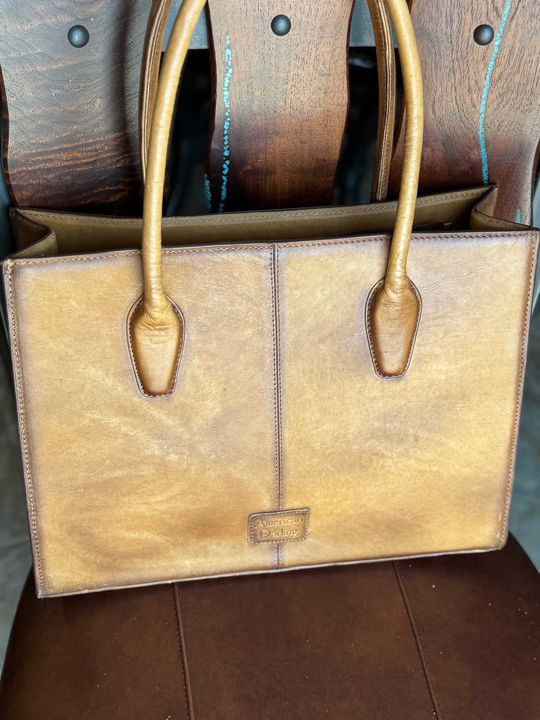 Back of briefcase, showing smooth distressed light brown leather