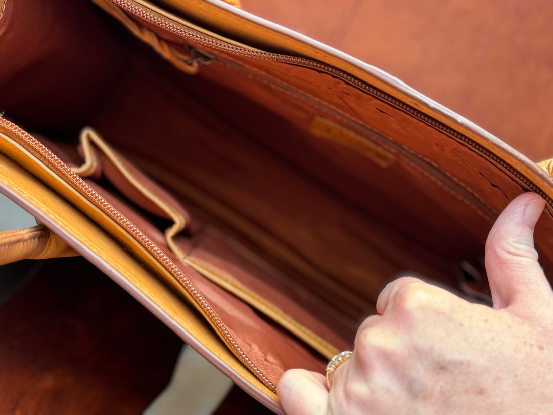 Showing interior of briefcase, with one small zippered pouch on one side and two small open pockets on the other side