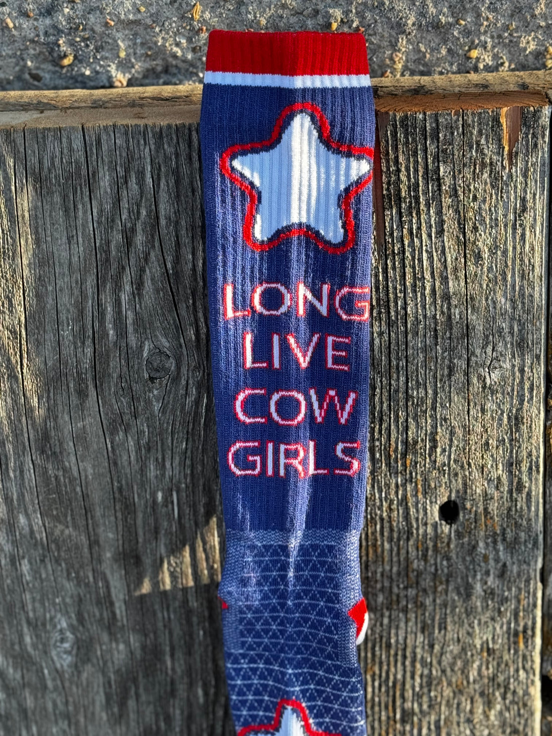 Sock with star design and text 'Long Live Cow Girls' on a wooden background