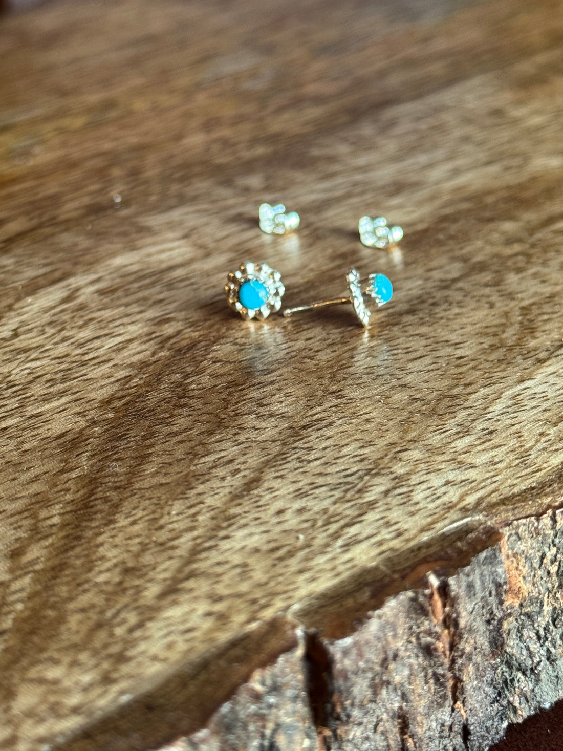 pair of turquoise and silver earrings on wooden background