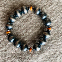 sterling silver ranch pearl stretchy bracelet  with orange beads on linen background