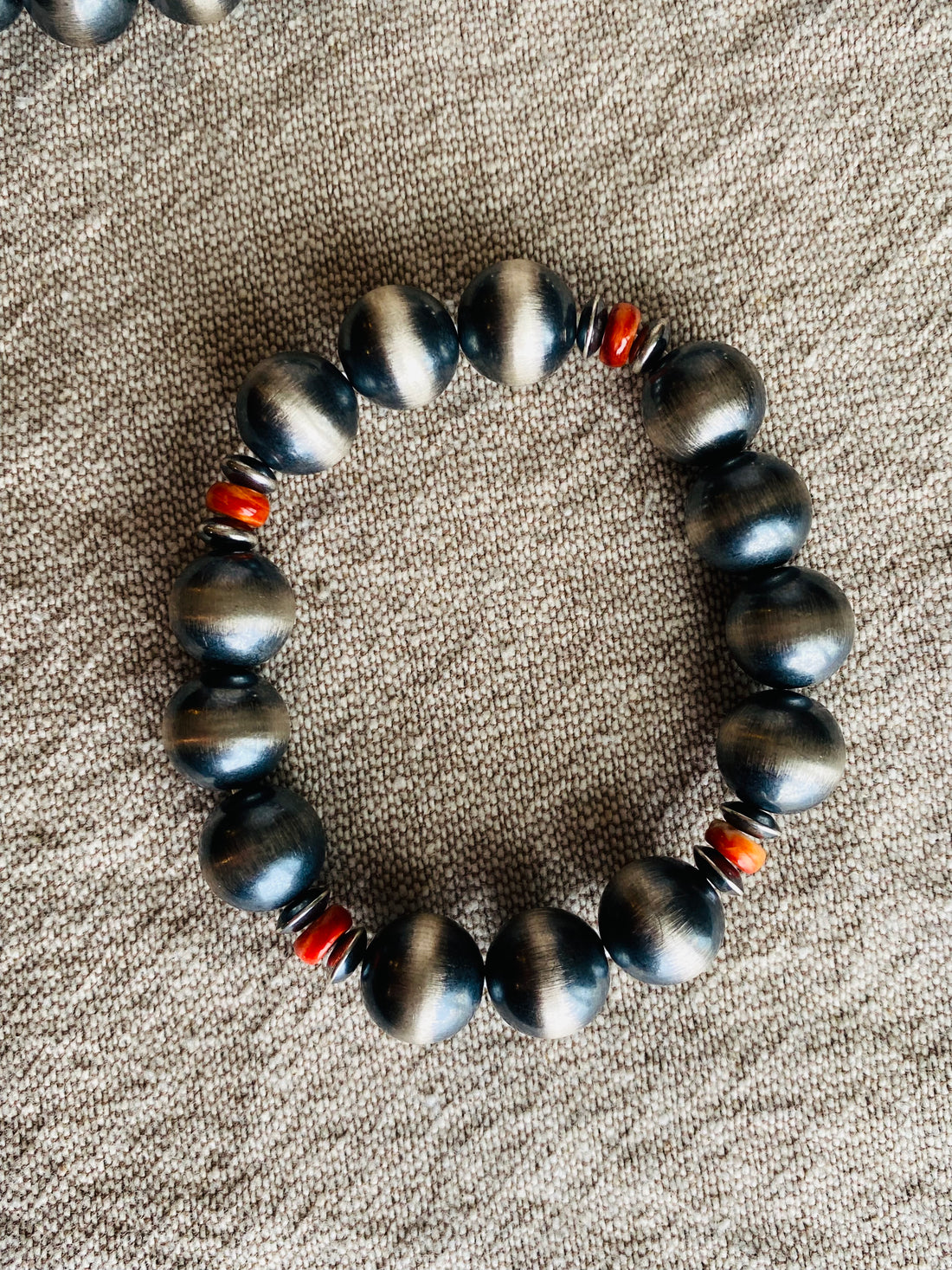 Sterling silver ranch pearls with red beads on linen background